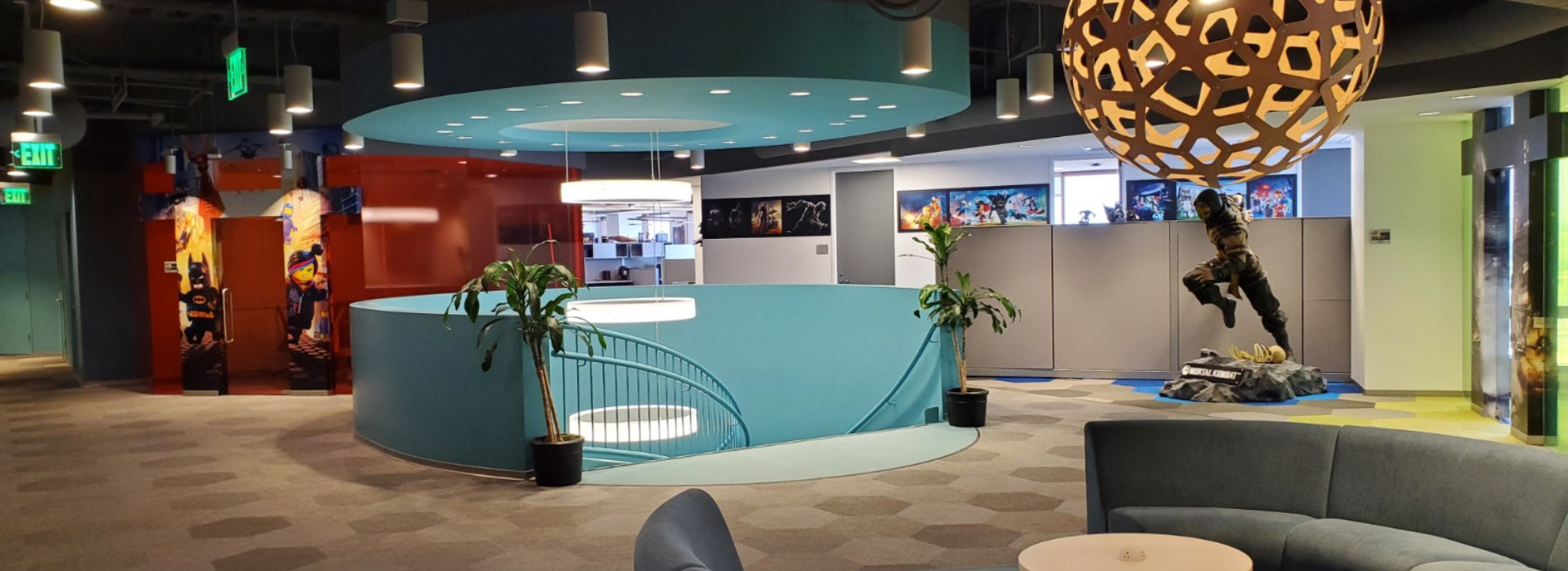 Image of the Warner Bros. Games office with a breakout area next to a staircase