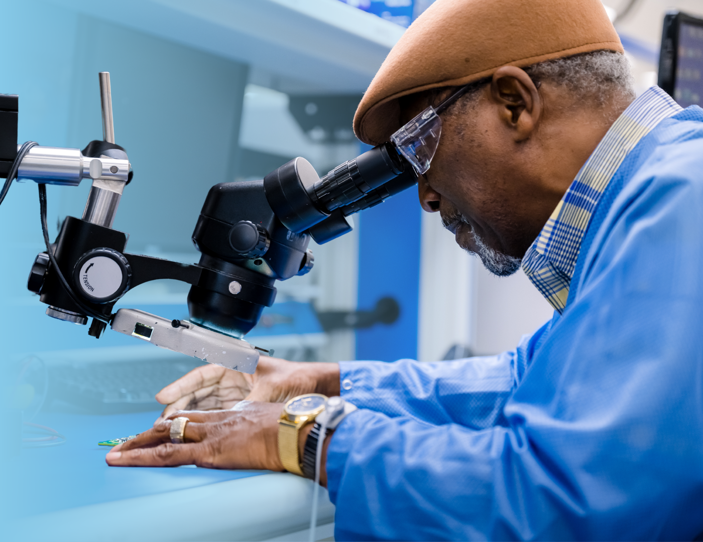 Elmer, a test technician, inspects a circuit board.