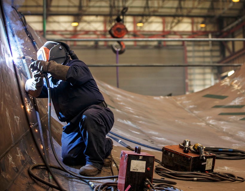 A welder working on a submarine.