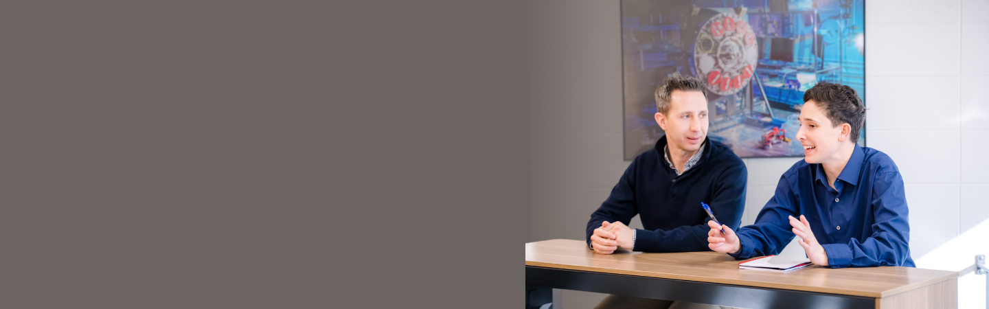 Two employees connect at a Space & Missions Systems facility. 