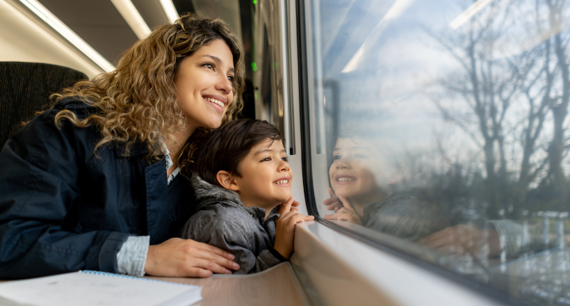 A mom and child ride the train.