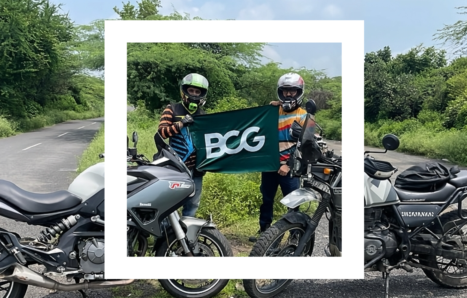 Two individuals standing on a roadside, each wearing full-face helmets and holding a flag with the letters 'BCG' printed on it. They are flanked by two motorcycles, one on each side of the image, with lush greenery in the background. The scene is framed within a white border that resembles a picture frame. 