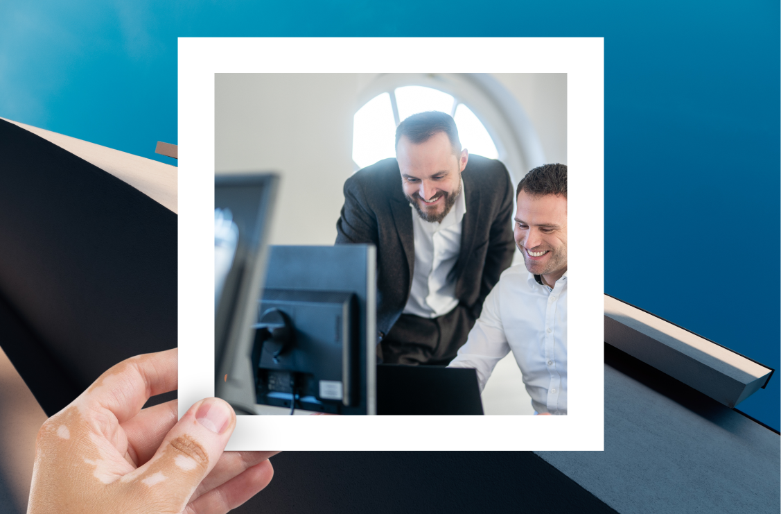 Two men working on a laptop