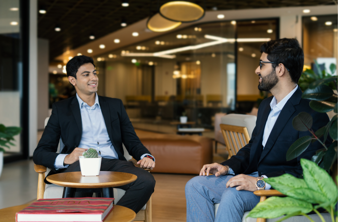 two men sitting in an office