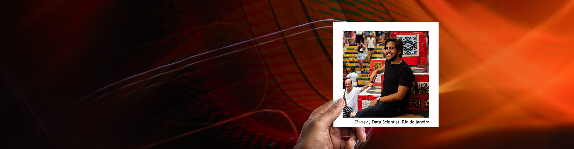 This panoramic banner showcases a hand holding a photograph against a dynamic abstract background with swirling patterns in fiery shades of red and orange. The photograph captures Pedro, a data scientist from Rio de Janeiro, sitting casually on the famous Selarón Steps, known for their colorful mosaic tiles. He is smiling, suggesting a relaxed and content demeanor in a vibrant, culturally rich setting. 