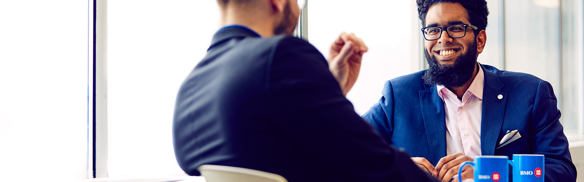 Two male coworkers having a coffee break.