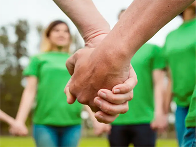 Volunteers holding hands