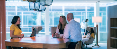 Employees having a meeting in the common area