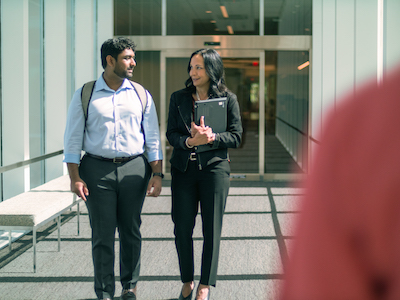 Employees in a discussion while walking