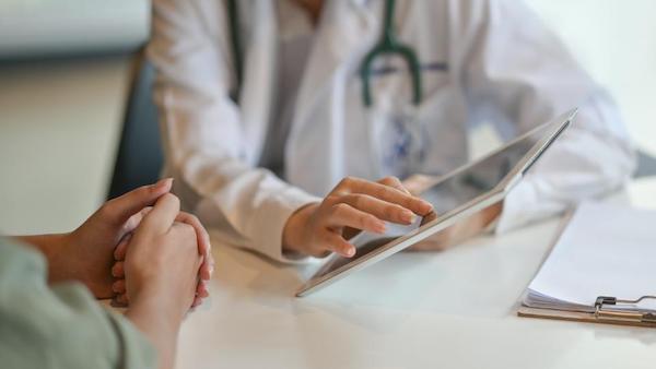 Doctor showing an ipad screen to a patient