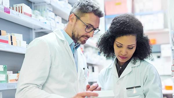 Pharmacy employees looking at a screen together