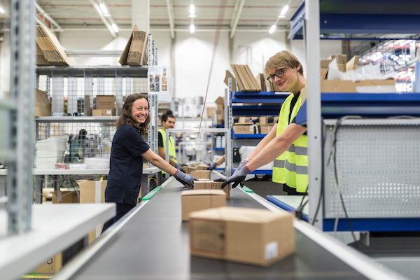 Employees working on conveyer belt 