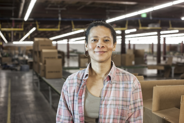 Employees posing in warehouse