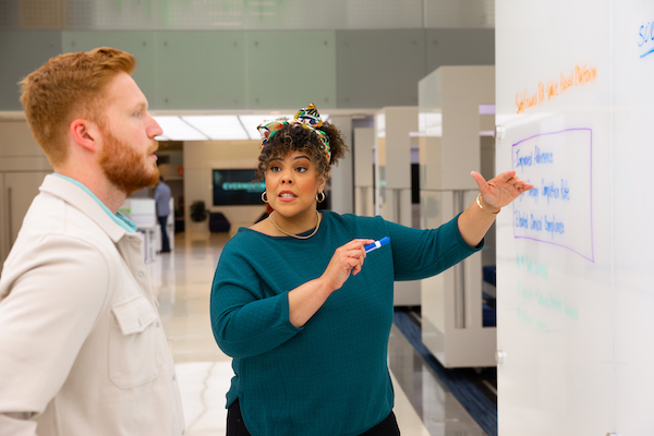 Male and female coworkers talking in an office common area