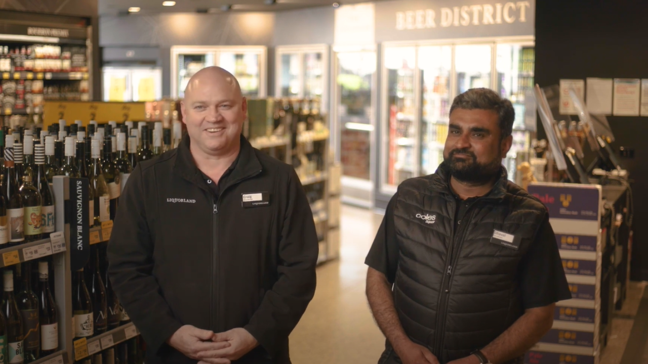 Two Liquorland store managers interacting in store