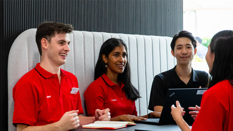 Coles team members sitting in a booth