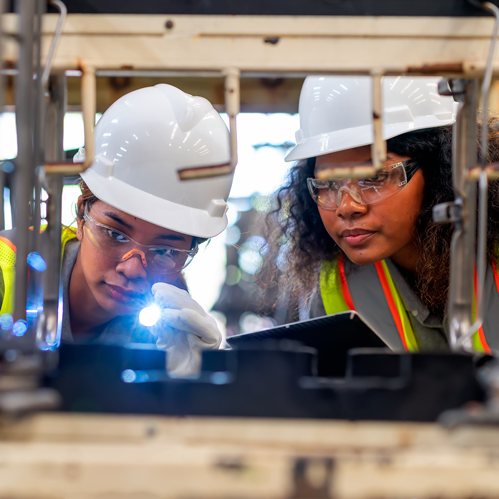 Engineers in a plant, one male one female