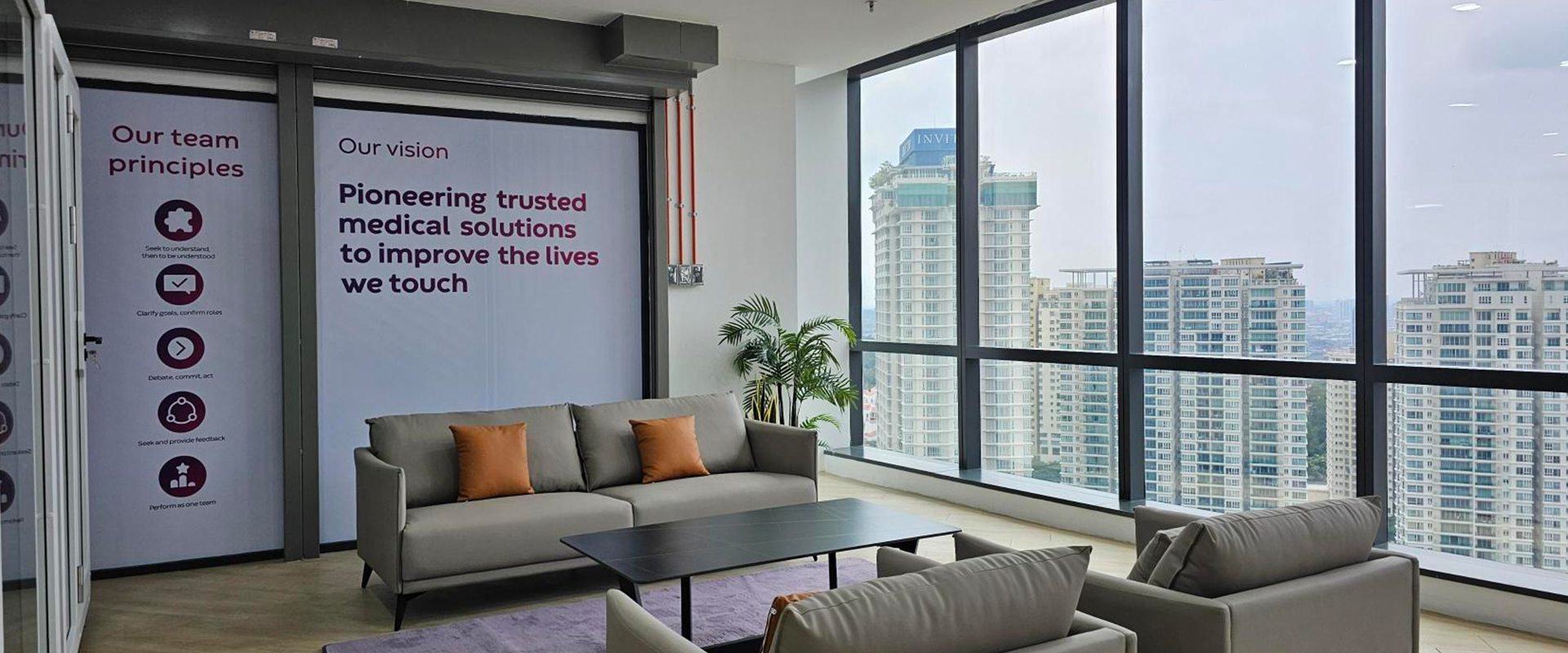 Image of the Kuala Lumpur office with sofas and decorative graphic walls