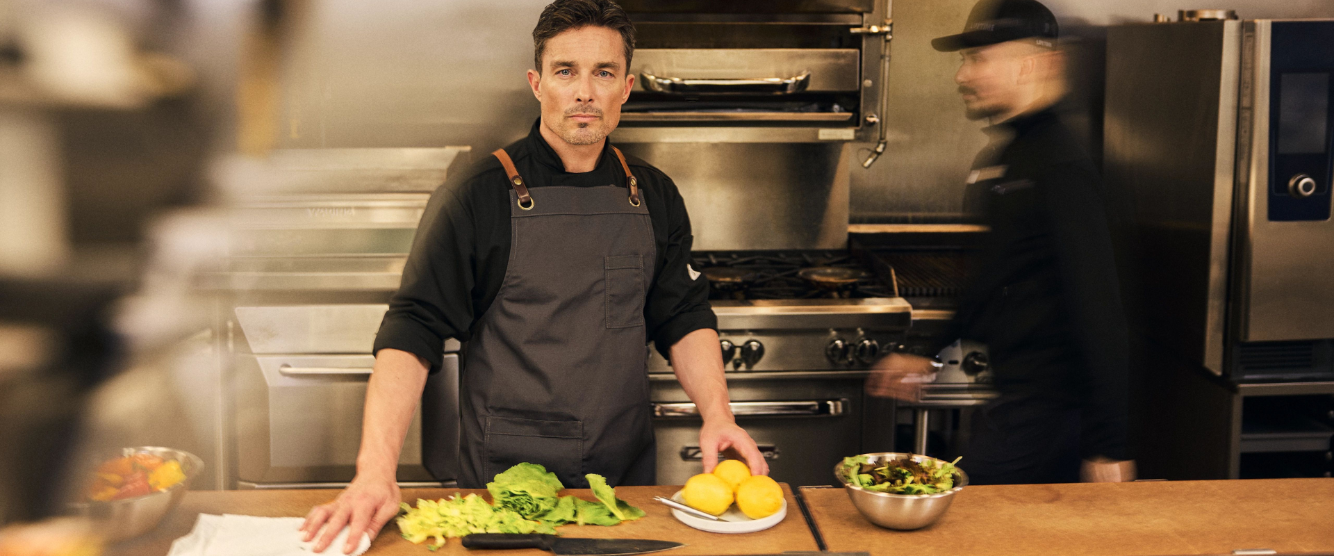 A chef preparing healthy meals in the Life Time kitchen.