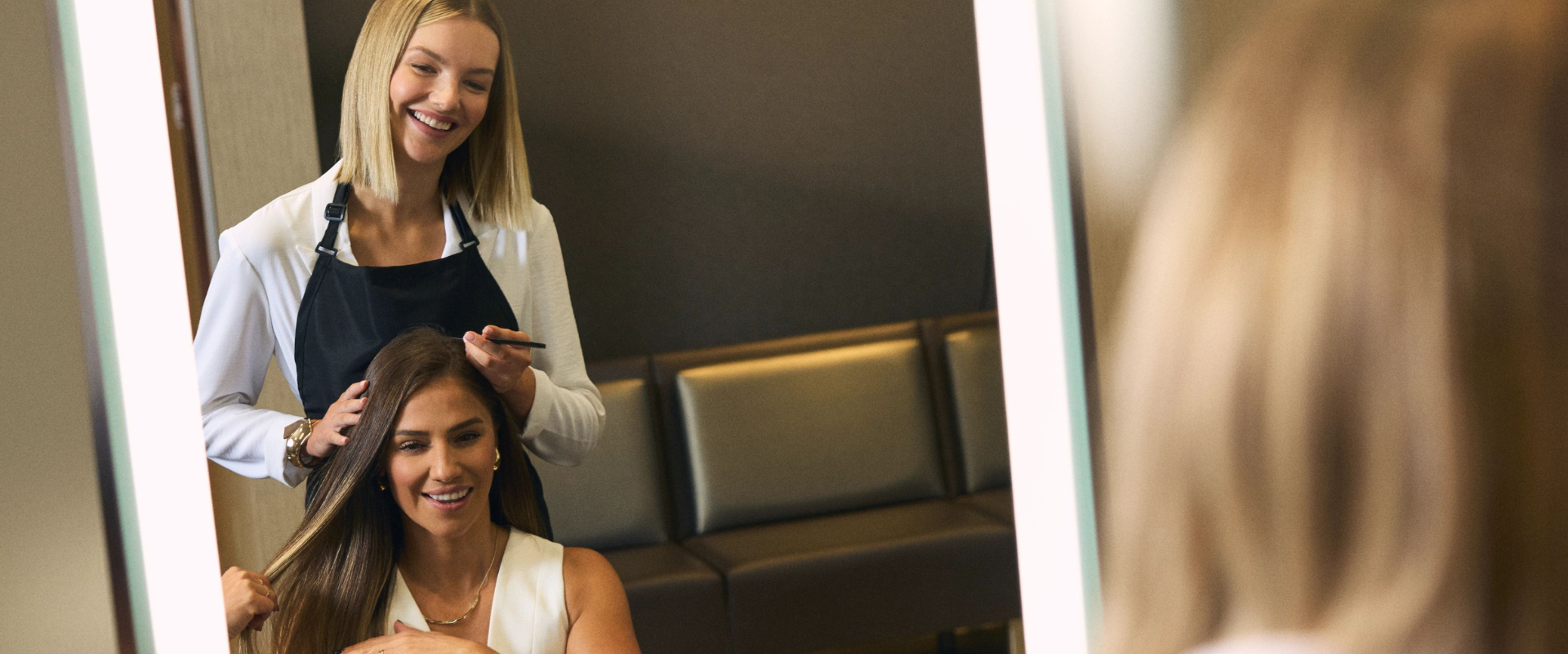 Life Time hairstylist performing a service on her client at the LifeSpa. 