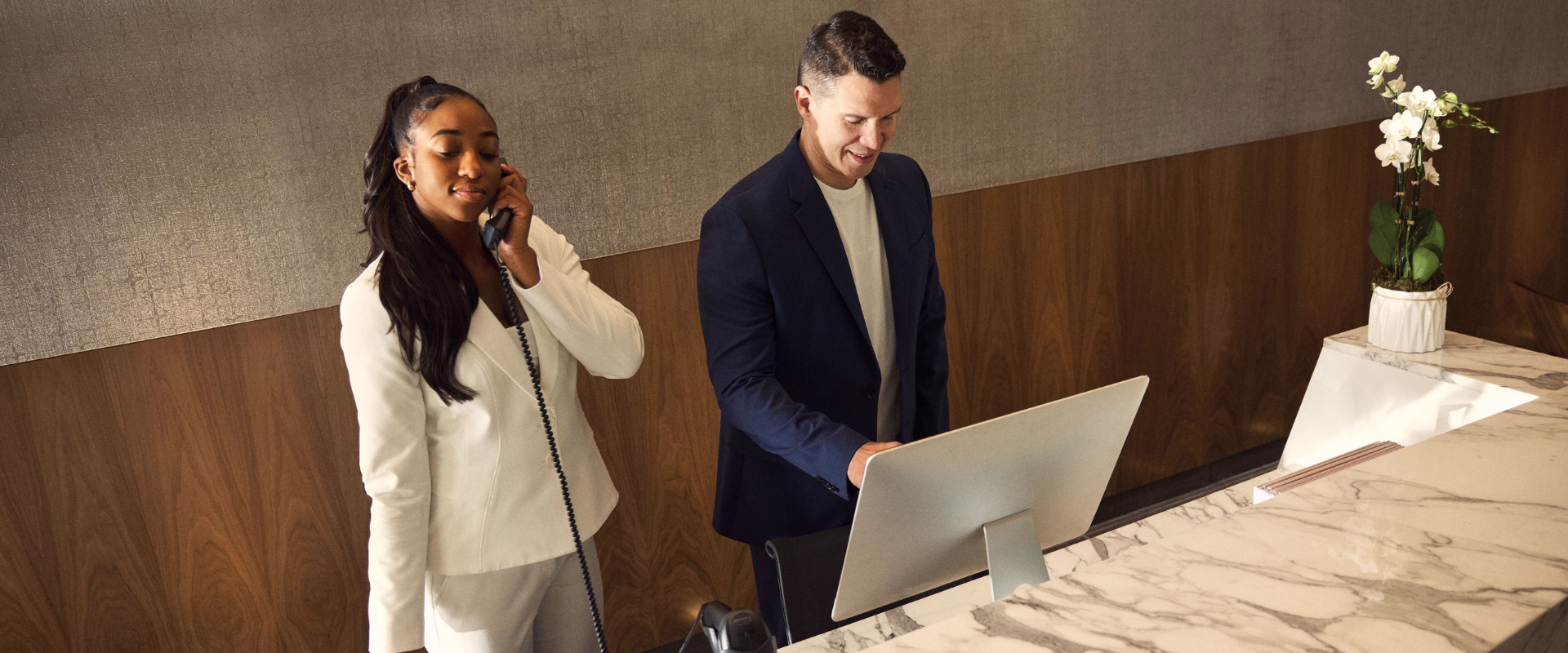 Two Life Time employees working the front concierge desk.