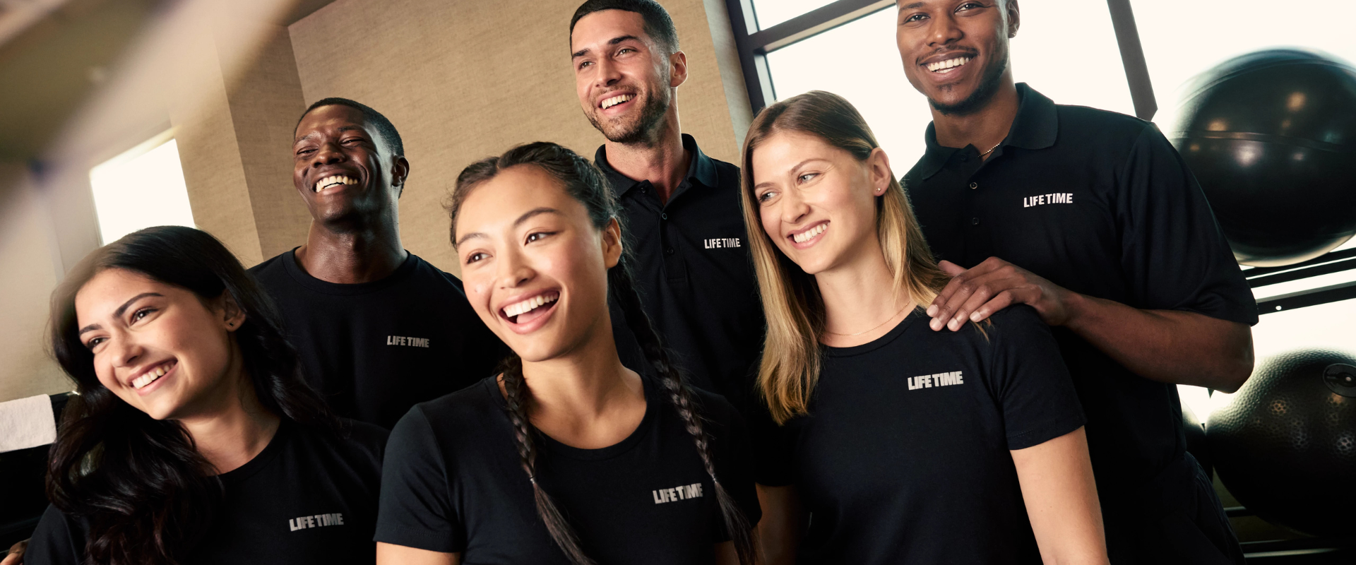 Life Time team members smiling and laughing together.