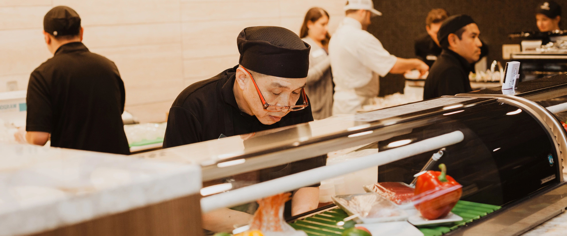 Life Time sushi cook preparing rolls.