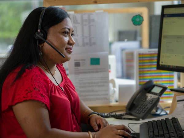 Supply Chain associate working in her office on a call