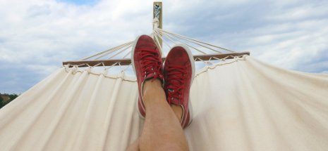 Photo of red shoes on a hammock with blue skies background