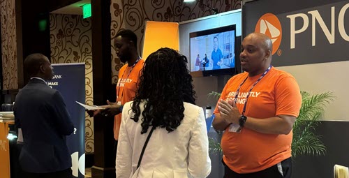 A group of recruiters standing for a photo at a conference booth