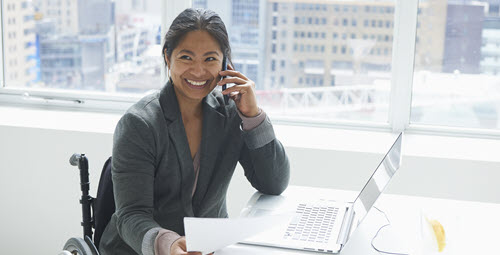 A woman smiling while talking on a cell phone