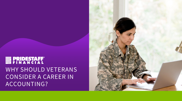 Military veteran woman sitting in a brightly lit room and typing on a laptop.