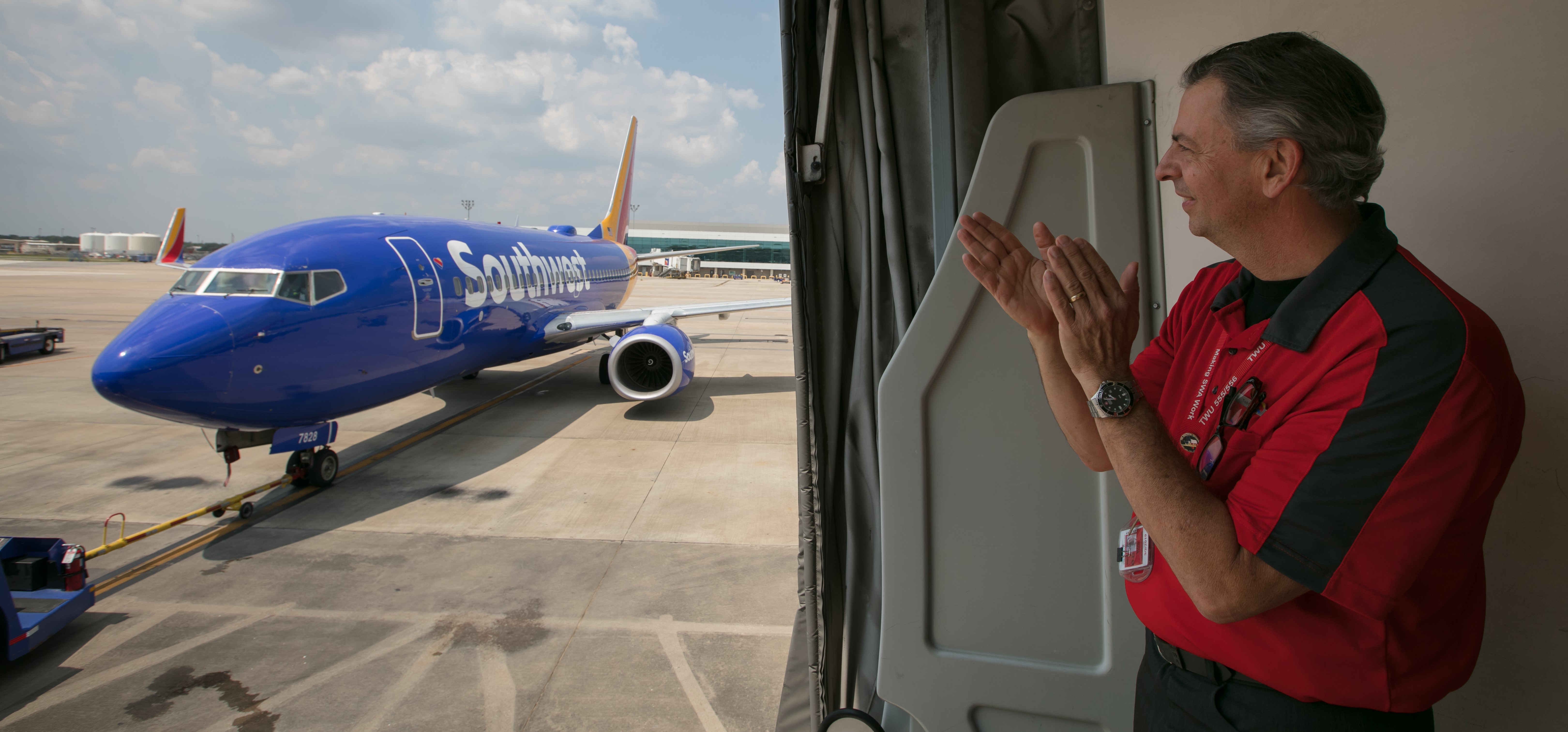 Operations Agent clapping looking at Southwest airplane.