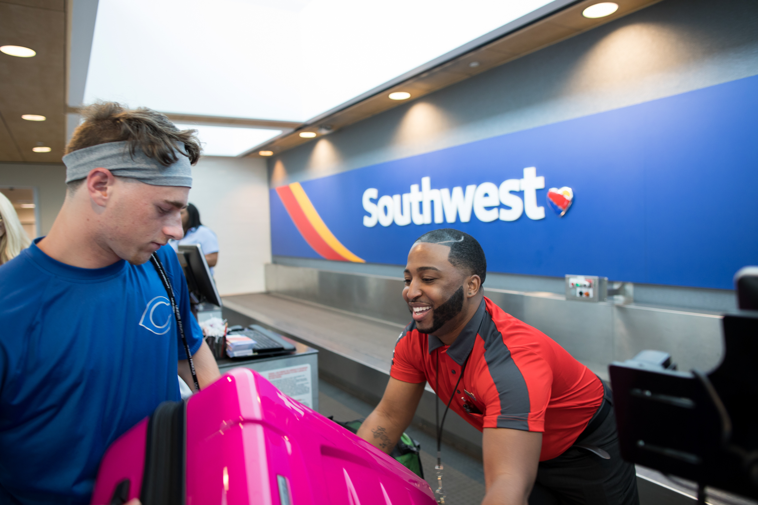 A Southwest Employee helps a Customer with his luggage