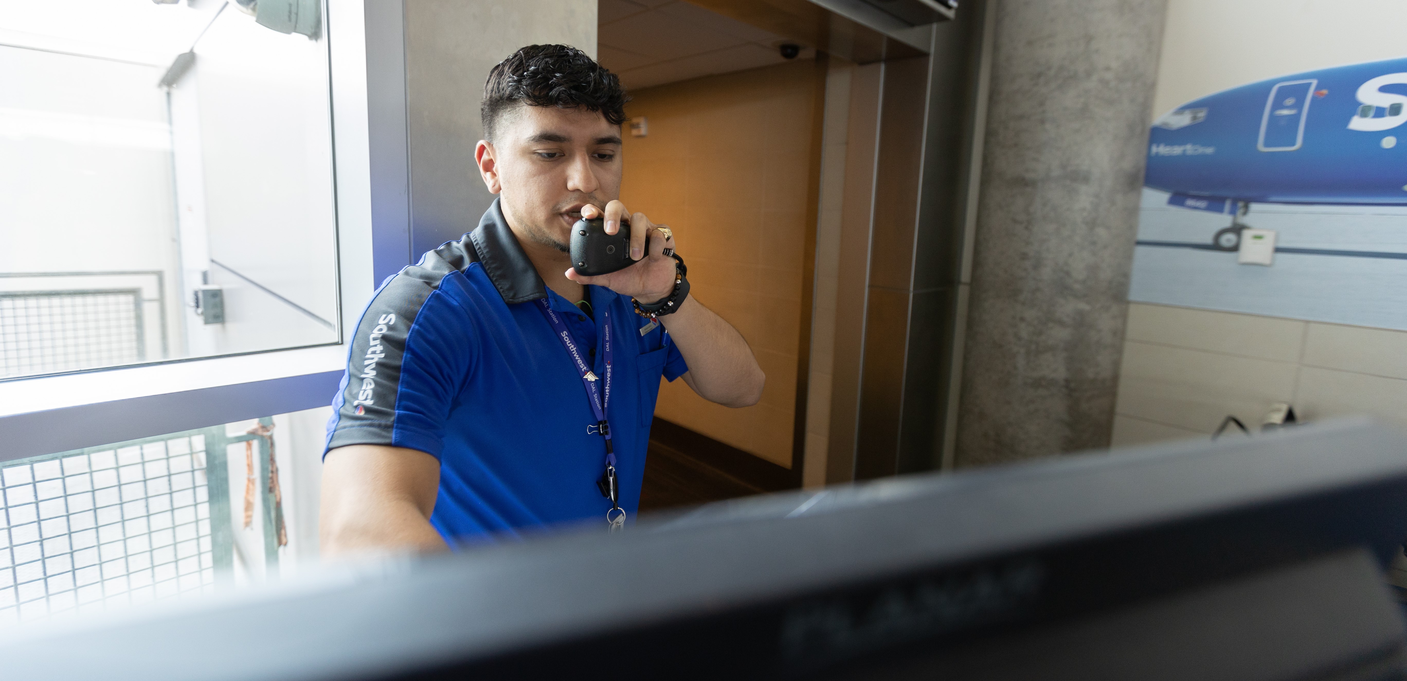 Southwest Operations Agent speaking into microphone to announce boarding instructions.