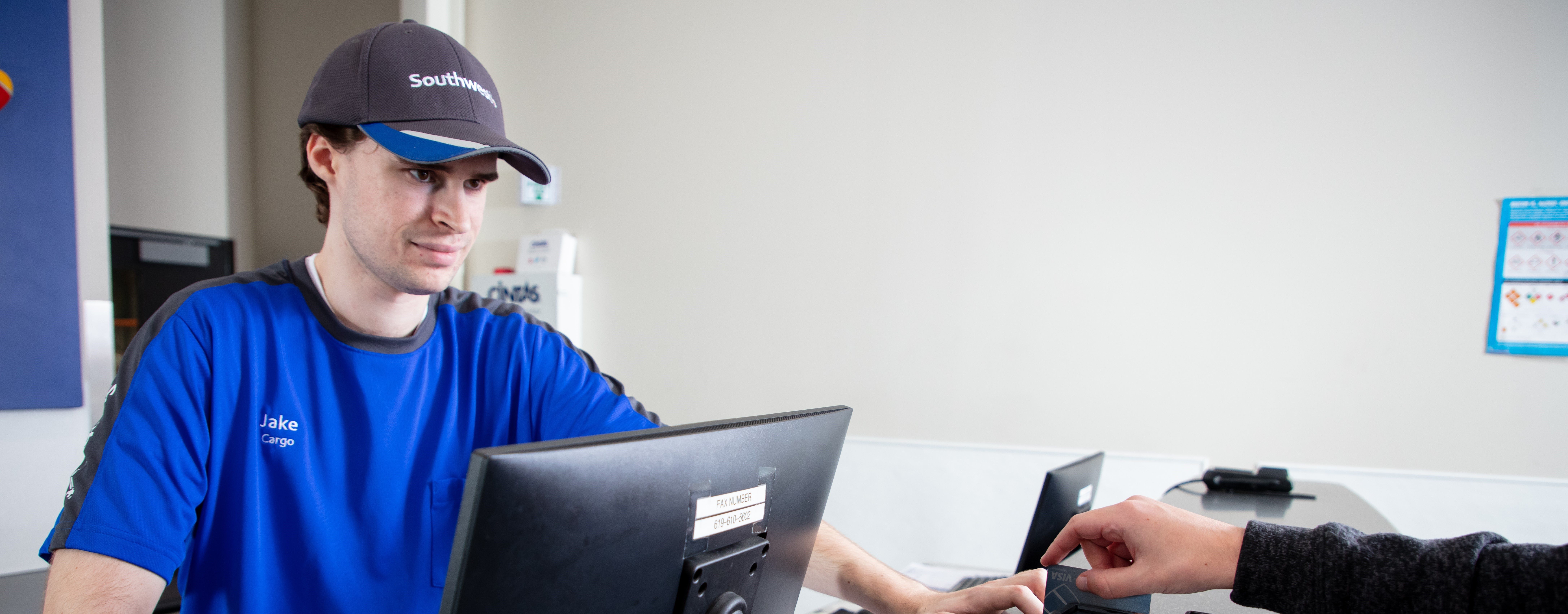 Southwest Cargo Agent taking payment from a customer