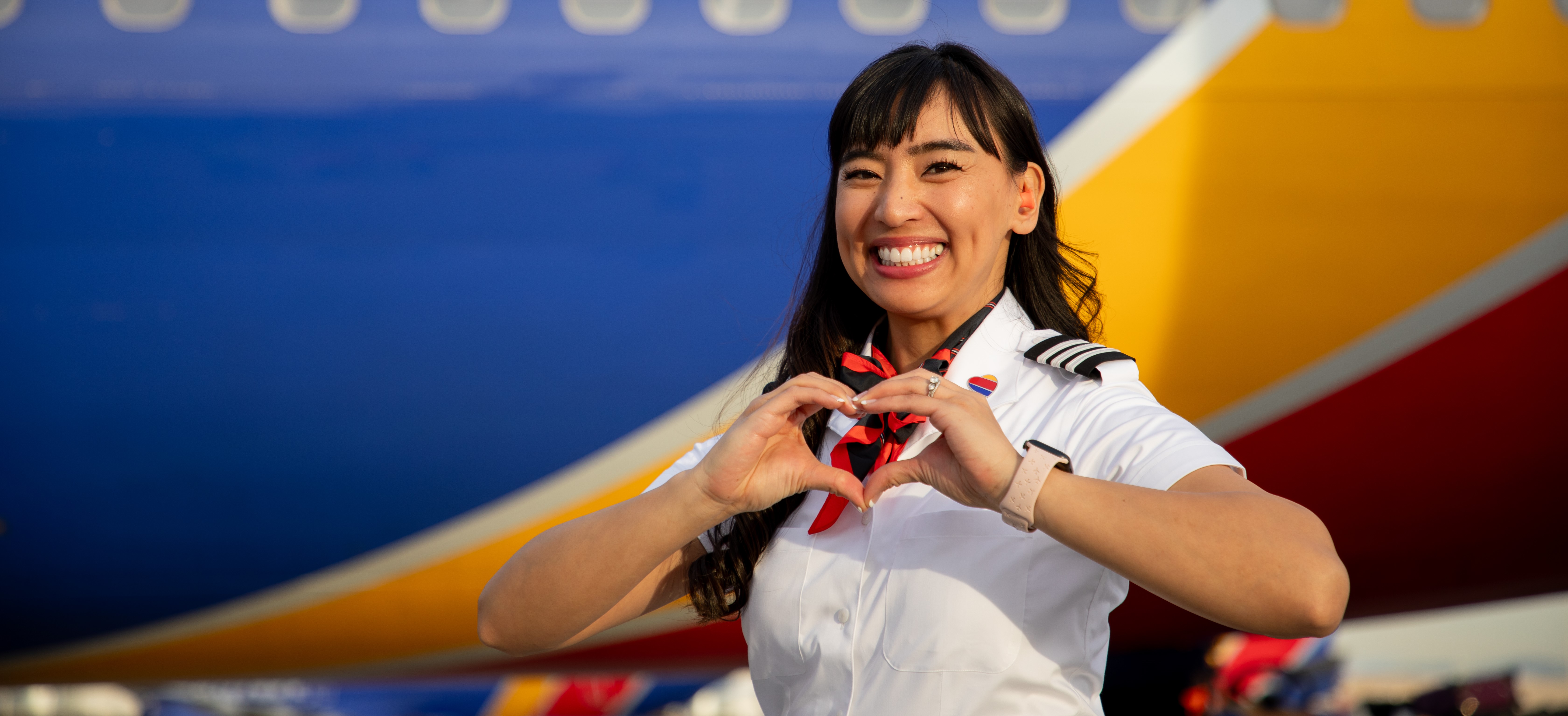 First Officer smiling making a hand heart.