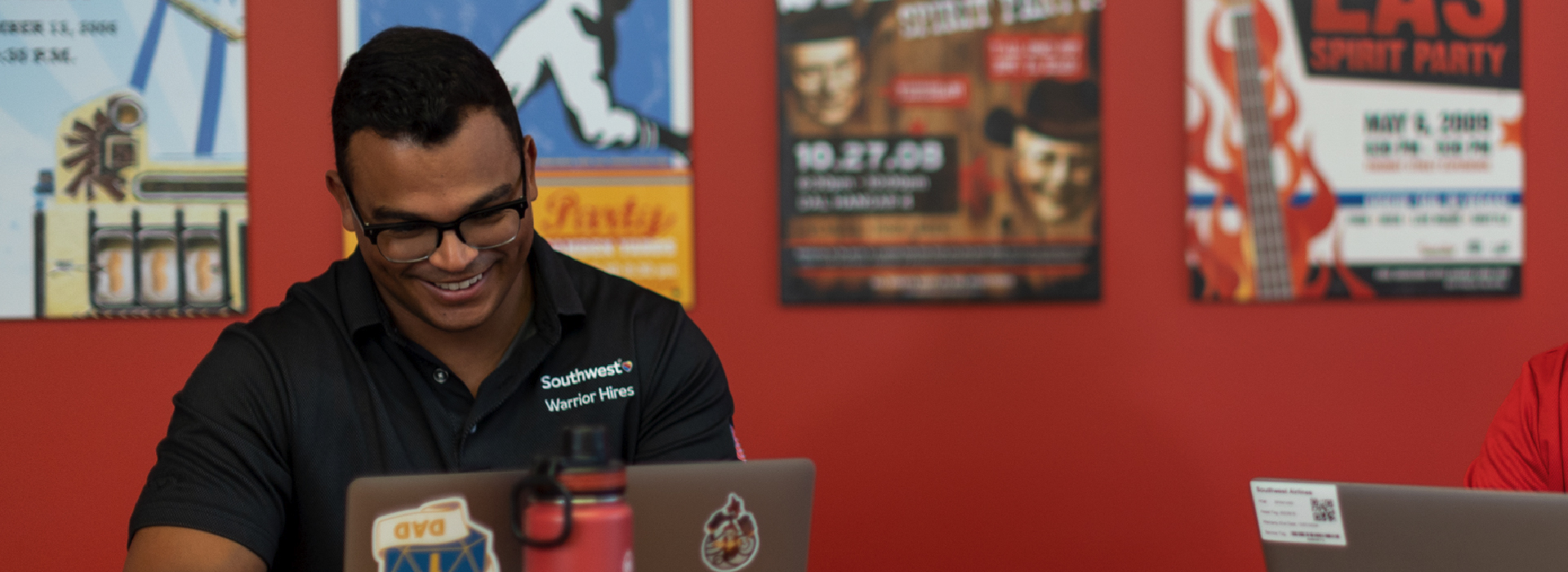 Photo of man smiling down at his laptop