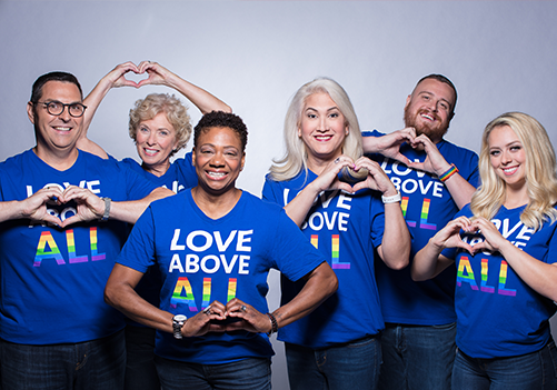 A group of Southwest Employees smiling and making hearts with their hands