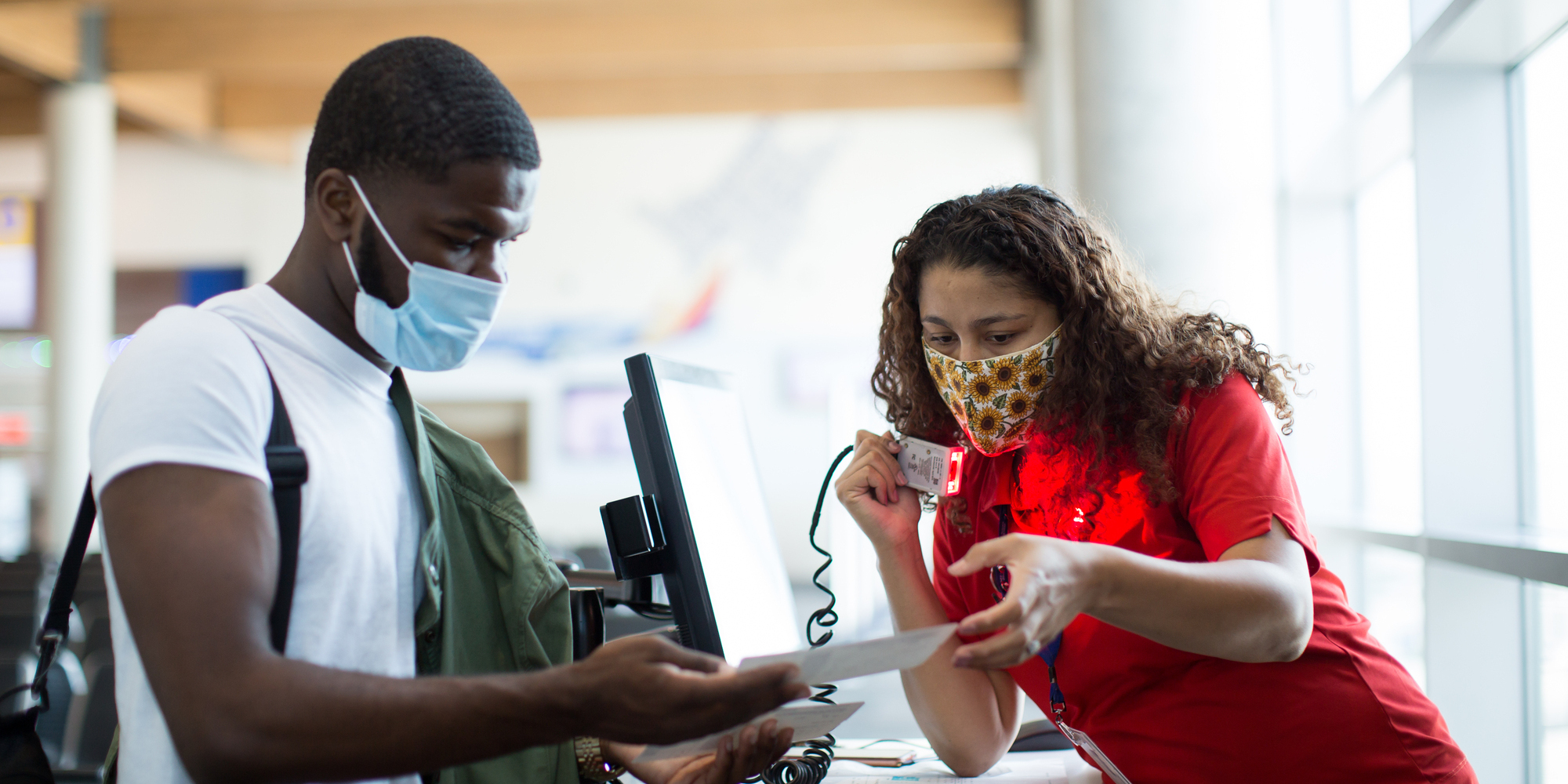 A Southwest Employee helps check in a Customer for a flight