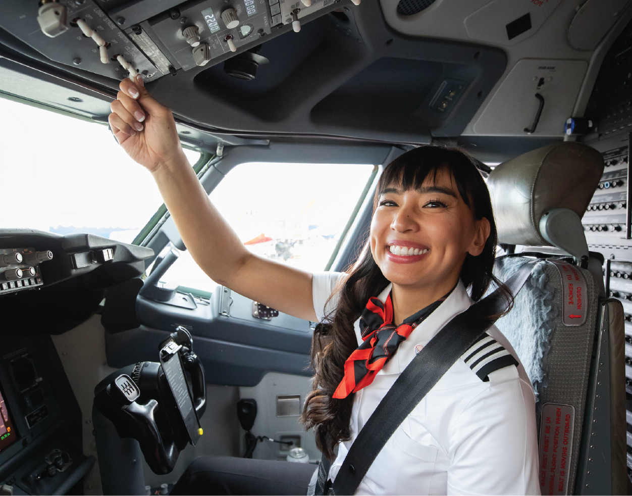 Photo of a smiling First Officer in the flight deck