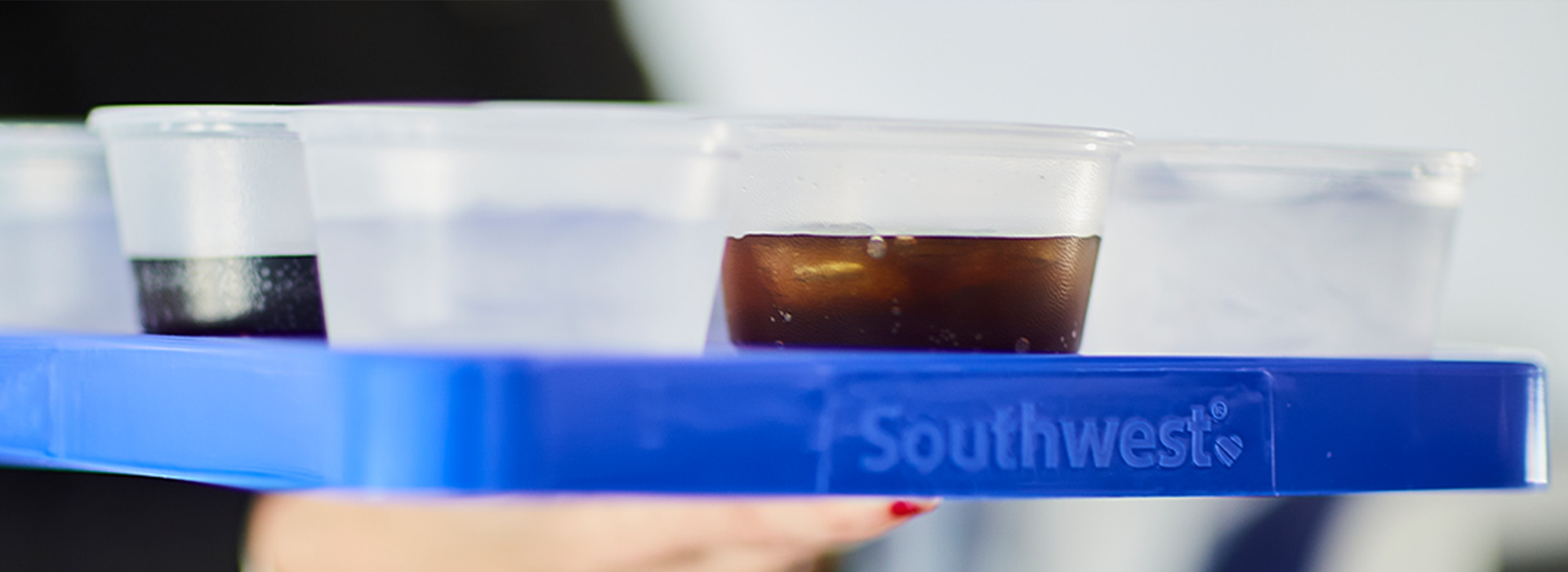 A flight Attendant's serving tray with a soda on it