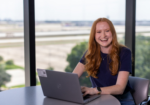 Portrait of female Southwest Employee smiling at her laptop