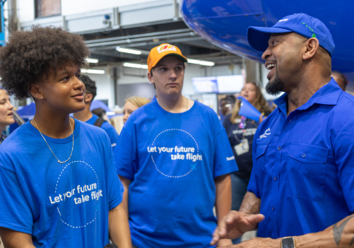 Aircraft Maintenance Technician talking with high school students