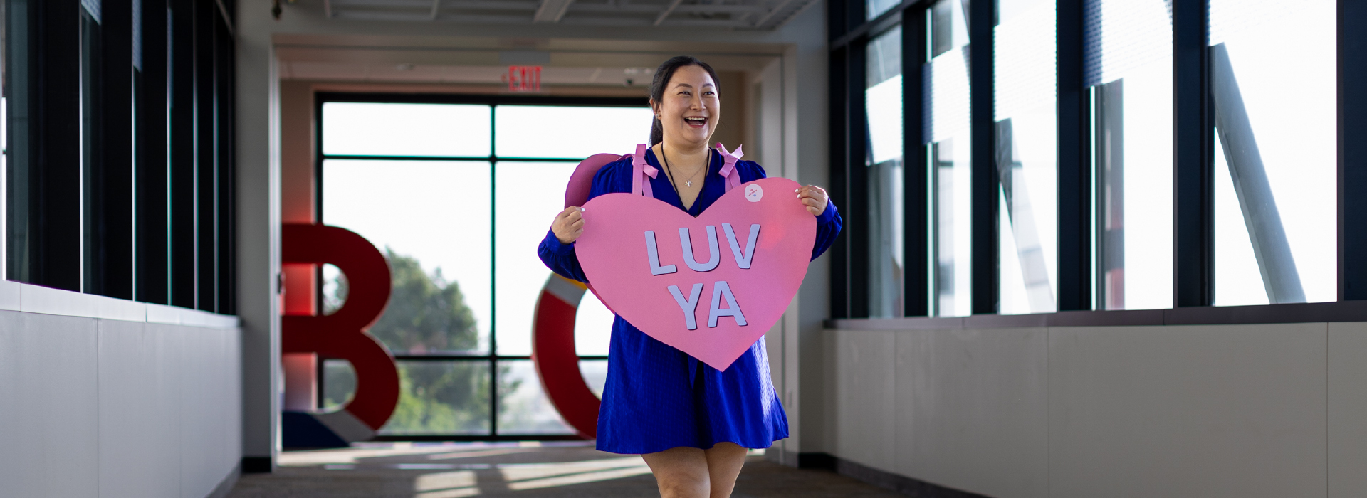 Woman smiling wearing a giant Heart