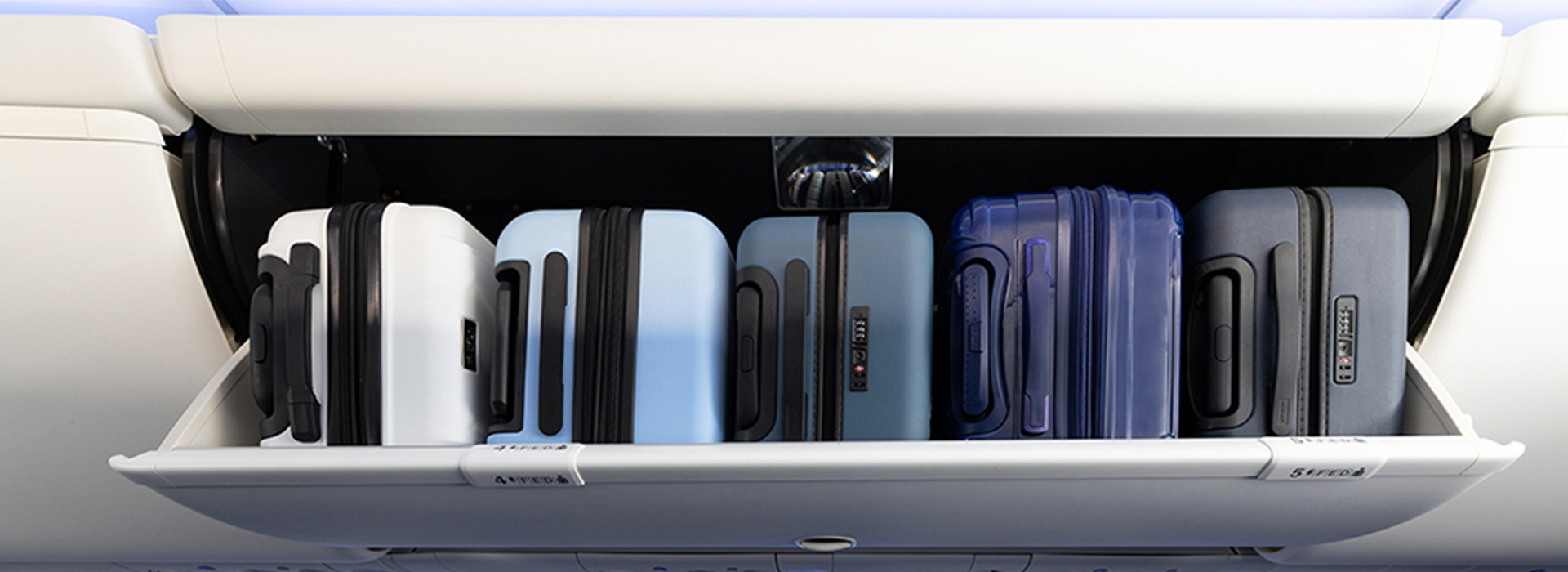 Luggage in the overhead bins on the plane