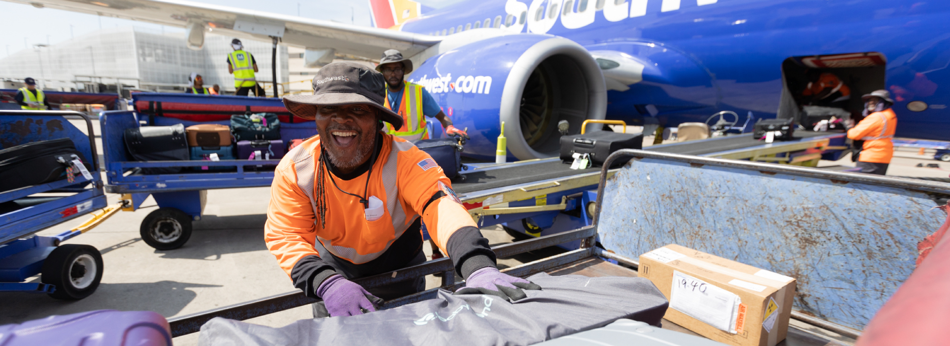 Southwest ramp agent unloading bags from a plane 