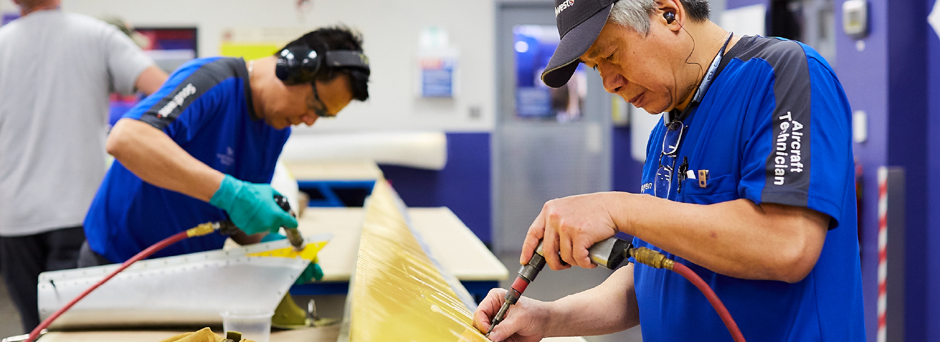 Aircraft Maintenance Technician working on an airplane part