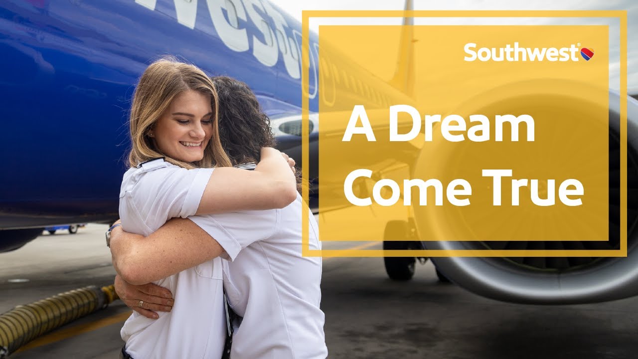 Mother and daughter Pilots hugging by a Southwest airplane
