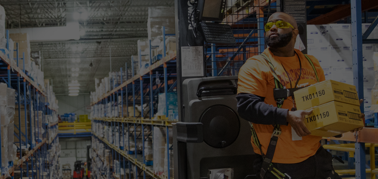 man in glasses with ear protection around neck